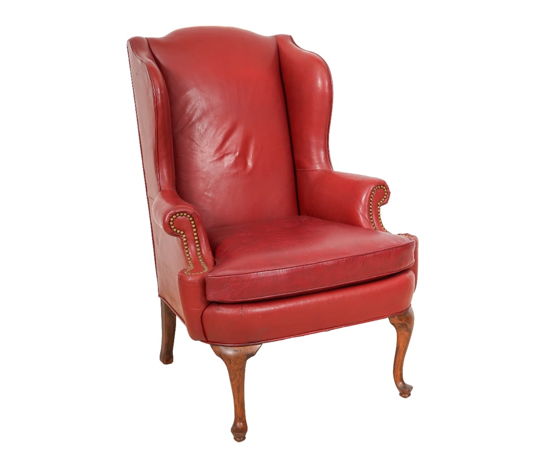 QUEEN ANNE STYLE LEATHER CHAIR: Queen Anne style red leather wing chair with brass studs. 44.5"h x 32"w x 21.5"d / 20" seat height