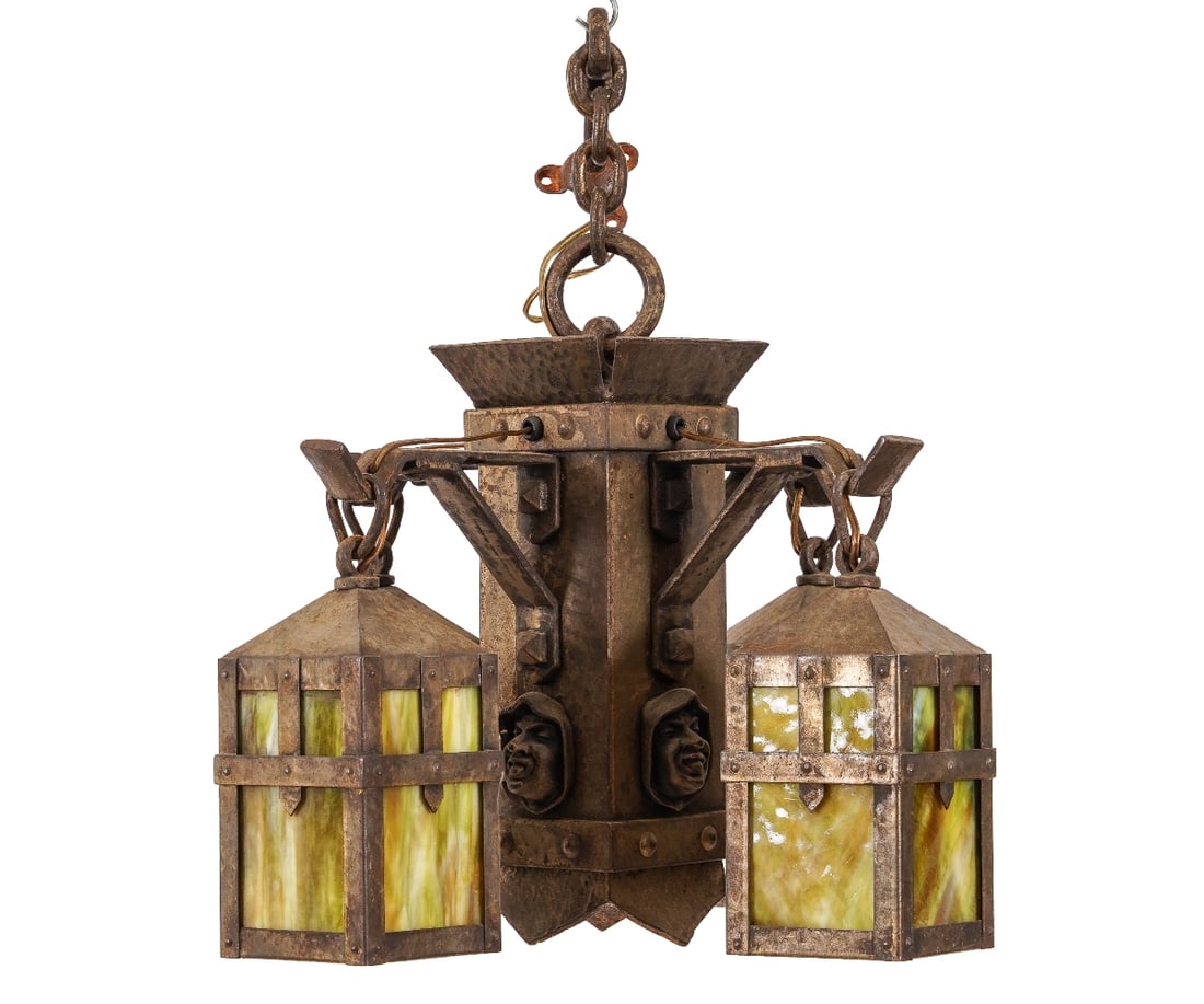 ARTS & CRAFTS CHANDELIER: Arts & Crafts hammered metal chandelier with monks head mask and four green slag glass lights, electrified. 14"h x 18"dia / Chain: 26"l