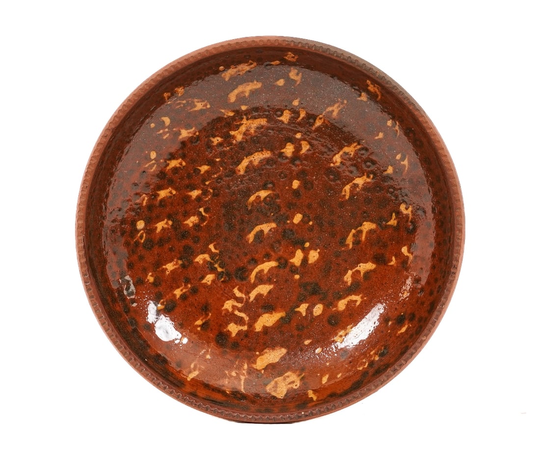 REDWARE PLATE: Redware deep plate with crimped border and mottled slip decoration, 19th c. 1.75"h x 9"dia