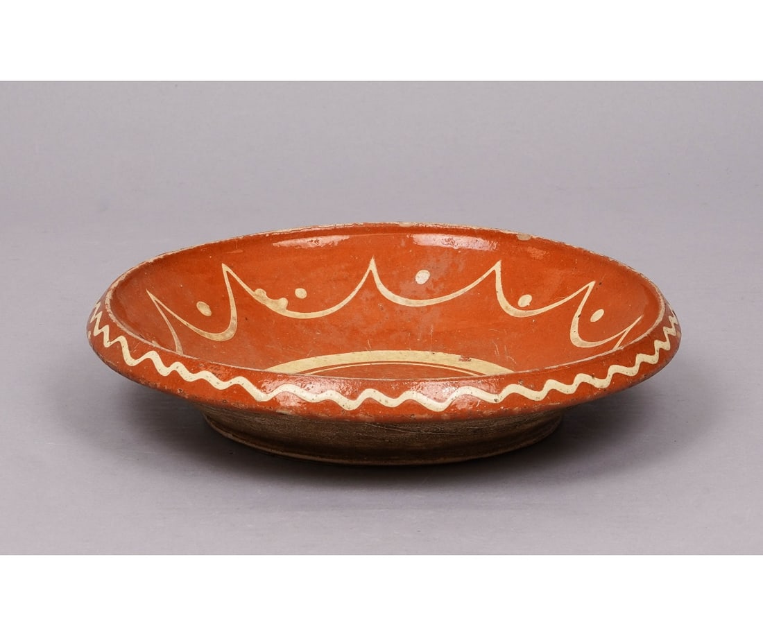 REDWARE PLATE: Redware deep plate 19th c., with yellow slip decoration. 2.5"h x 12"dia