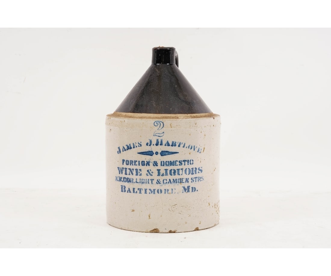 STONEWARE LIQUOR JUG: Two-gallon stoneware liquor jug advertizing "James J. Hartlove, Wine & Liquors, Baltimore, MD". 14.5"h x 8.5"dia