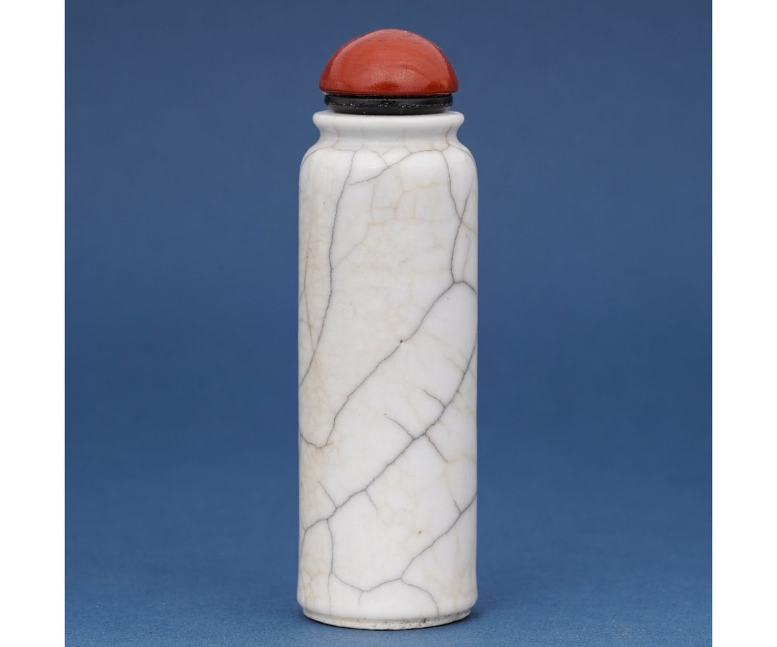CHINESE PORCELAIN SUFF BOTTLE: Chinese white porcelain snuff bottle, 19th c. with red stopper. 3.75"h x 1.125dia