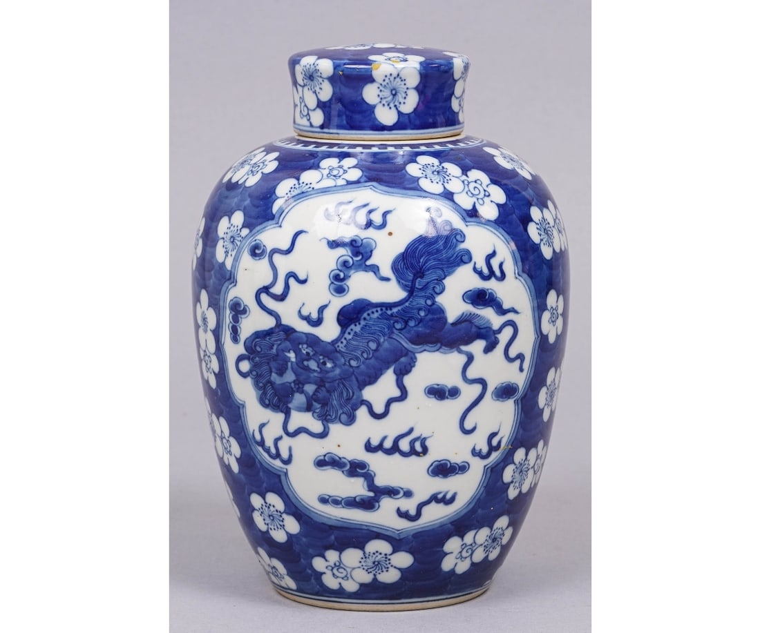 CHINESE PORCELAIN GINGER JAR: Chinese porcelain ginger jar with Foo dragon panel, cherry blossoms on a blue ground. 8.5"h x 6"dia