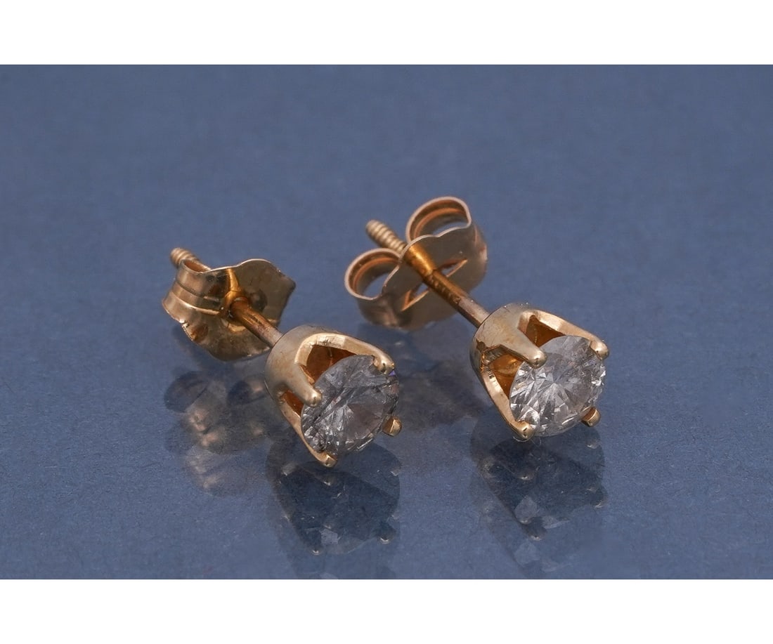 14K GOLD DIAMOND EARRINGS: 14k yellow gold diamond stud earrings featuring two round brilliant cut diamonds each set in 4 prongs with threaded posts (one threaded back and one friction back. Diamond weights: .48ct each / Color: