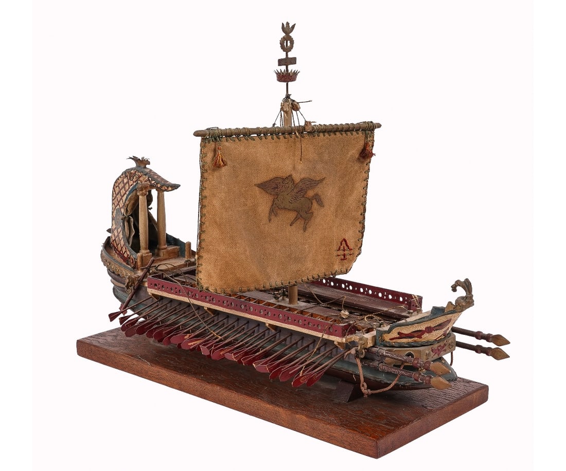 WOODEN SHIP MODEL: Wooden ship model of a multi-oared Greek war/ram ship with a Pegasus sail. 15"h x 21"l x 8.5"d