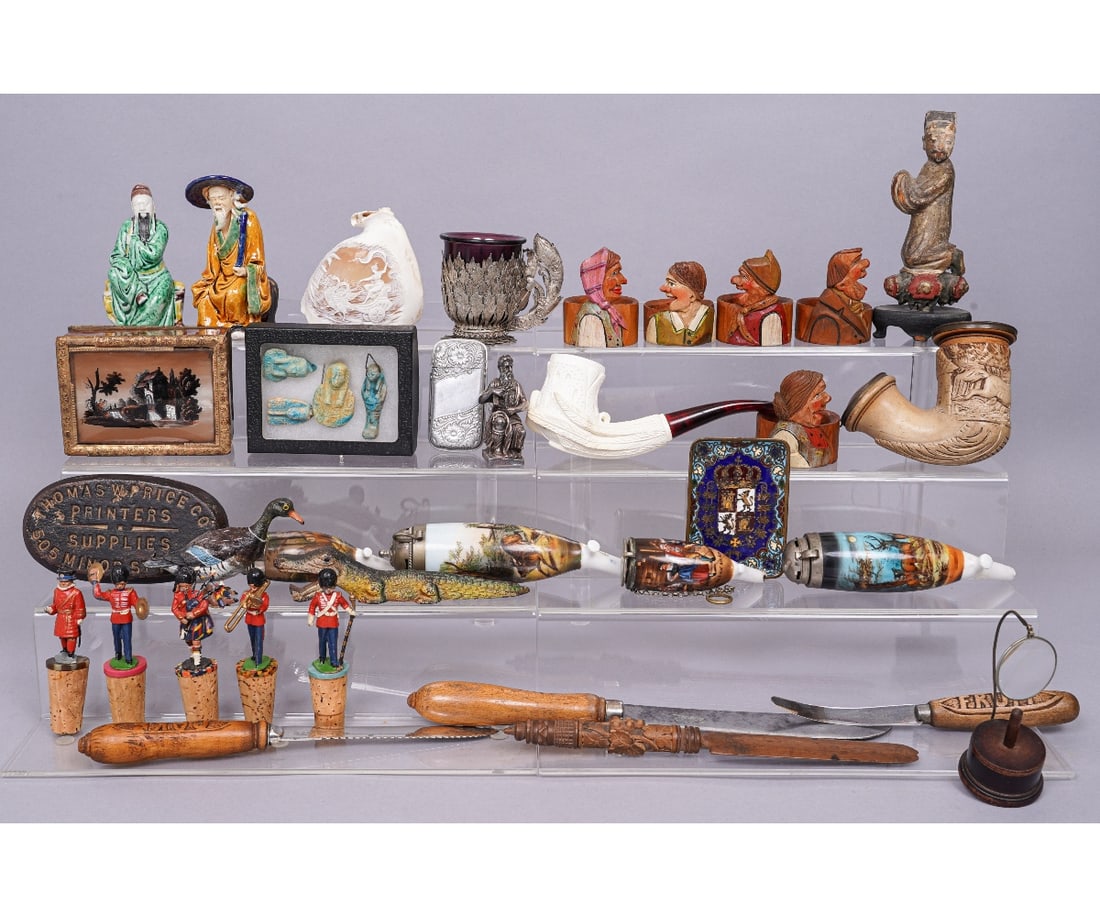 MISCELLANEOUS GROUPING: Miscellaneous grouping to include German porcelain pipes, bread knives, English wine corks topped with lead parade figures including a bagpiper. Tallest figure: 7.5"h x 3"w x 2.5"d