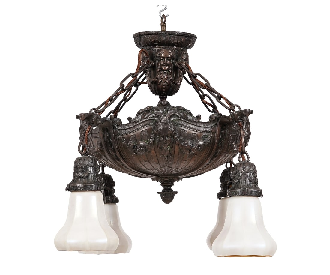 FRENCH ART NOUVEAU CHANDELIER: French Art Nouveau repoussé metal chandelier signed B&K, decorated with mask heads, with four drop Quezell opalescent pendant shades, the shades signed.19"h x 21"w