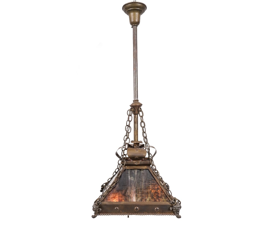 ARTS & CRAFTS PENDANT LIGHT: Arts & Crafts pyramid form hanging pendant light with four slag glass panels and cast metal devil masks at each corner. 37"h x 16"w x 16"d
