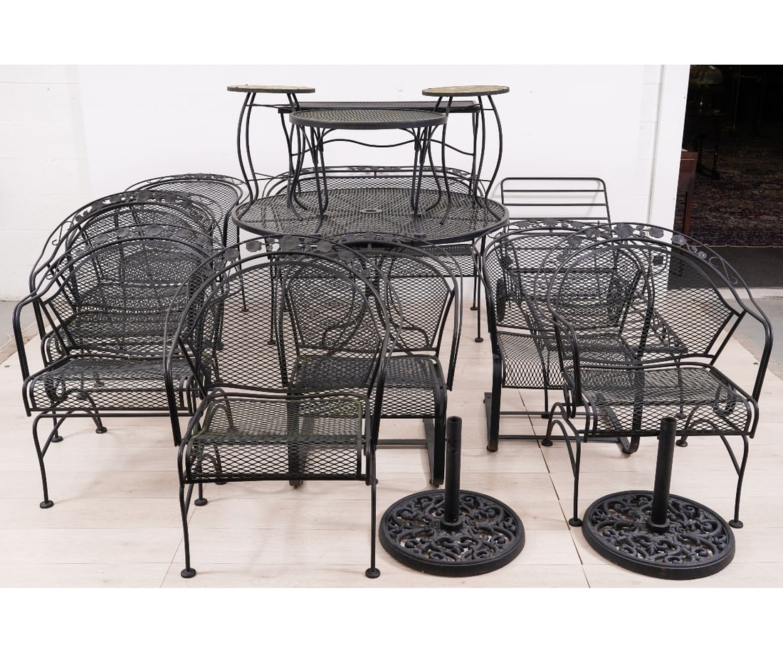 WOODARD WROUGHT IRON FURNITURE: Large wrought iron outdoor furniture set by Russell Woodard to include a round table, settee, chaise lounge, 8 armchairs, two umbrella stands, two small tables and two small 'peacock' tables and many