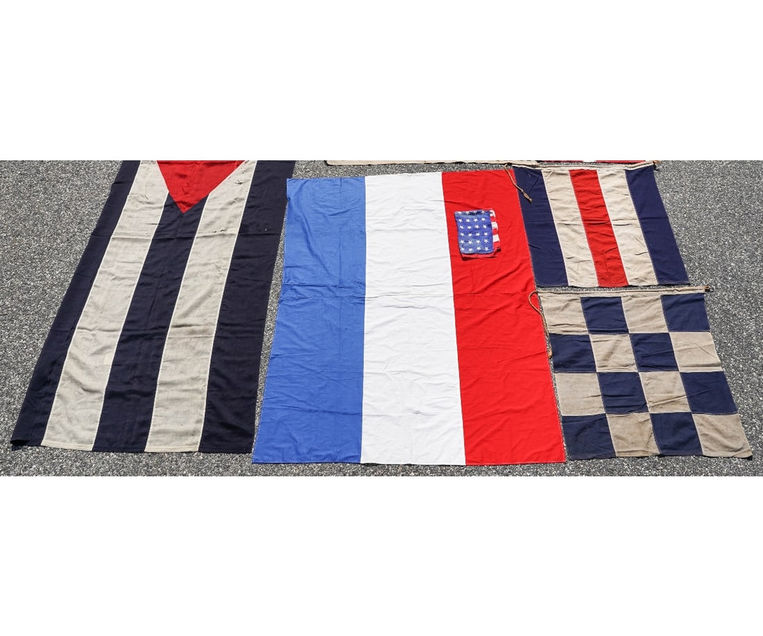 GROUPING OF FLAGS: Grouping of flags to include a large flag "From the Government of Cuba 1932", 98"h x 46" (holes); together with small signal flags. Provenance: Approved for deaccession from the Independence Seaport M