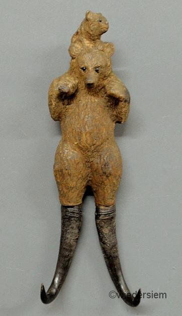 Black Forest carved coat hook, late 19th c., in th: Black Forest carved coat hook, late 19th c., in the form of a bear with cub and horn legs. 13.5”h.