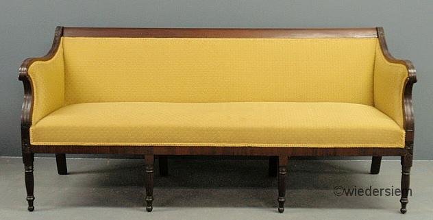 Sheraton mahogany sofa, c.1820, with acanthus and: Sheraton mahogany sofa, c.1820, with acanthus and reeded carvings and turned reeded legs. 35”h.x75.5”l.x28”d., seat 18”h.