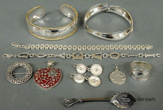 Group of sterling silver jewelry to include a Tiff: Group of sterling silver jewelry to include a Tiffany bangle bracelet, another bangle with gold colored rims, 2 link bracelets, filigree pin, red enameled heart pendant, pair of wire double drop earri