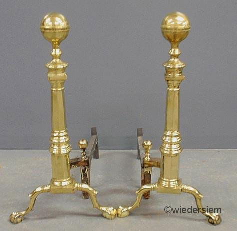 Pair of brass Colonial Revival andirons signed “Th: Pair of brass Colonial Revival andirons signed “The Marvin Co., Baltimore”. 26”h.x14”w.x24”d.