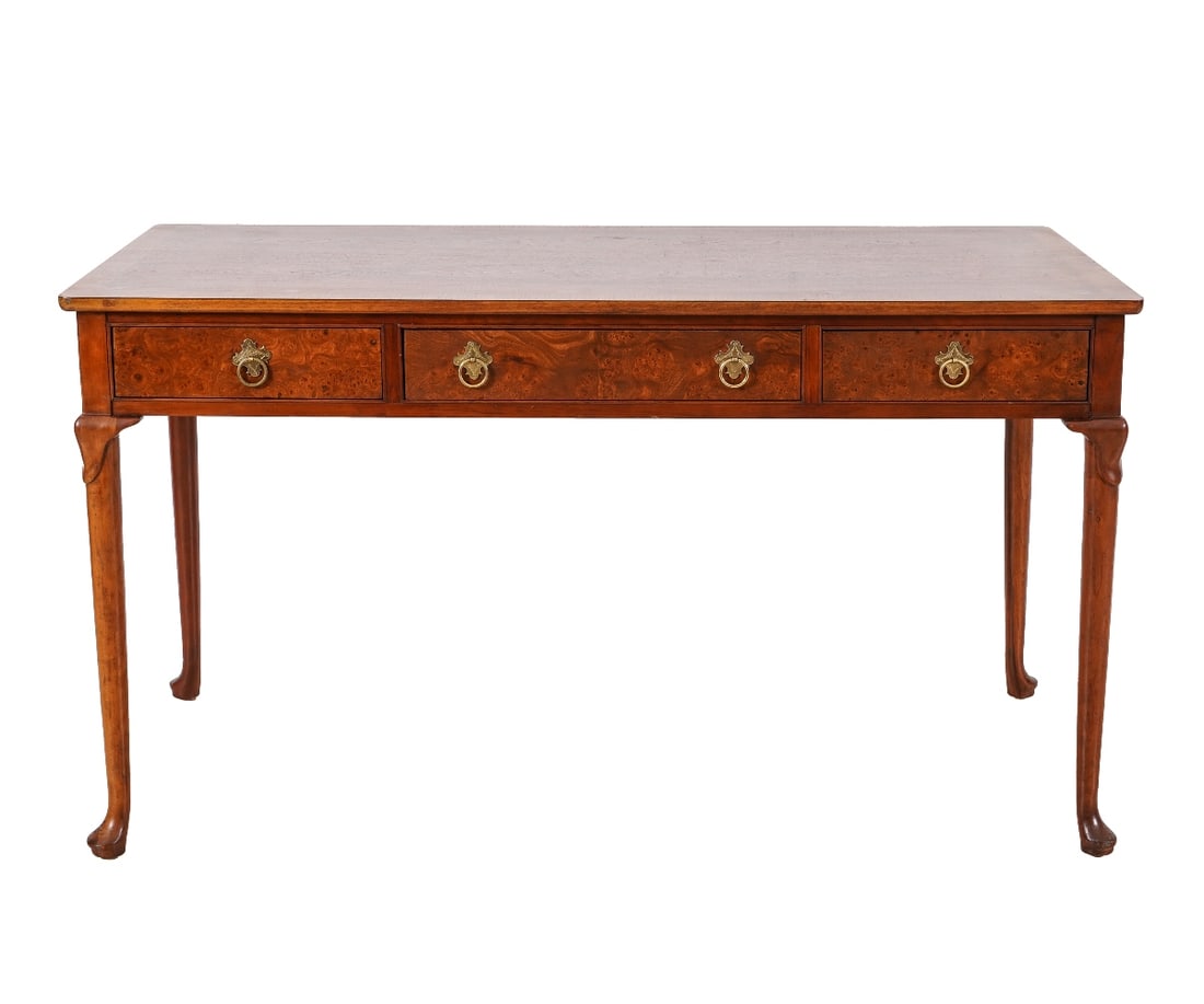BAKER FURNITURE DESK: Labeled Baker Furniture Co. Queen Anne style mahogany three-drawer desk with burl drawer fronts. 30"h x 54"l x 26"d