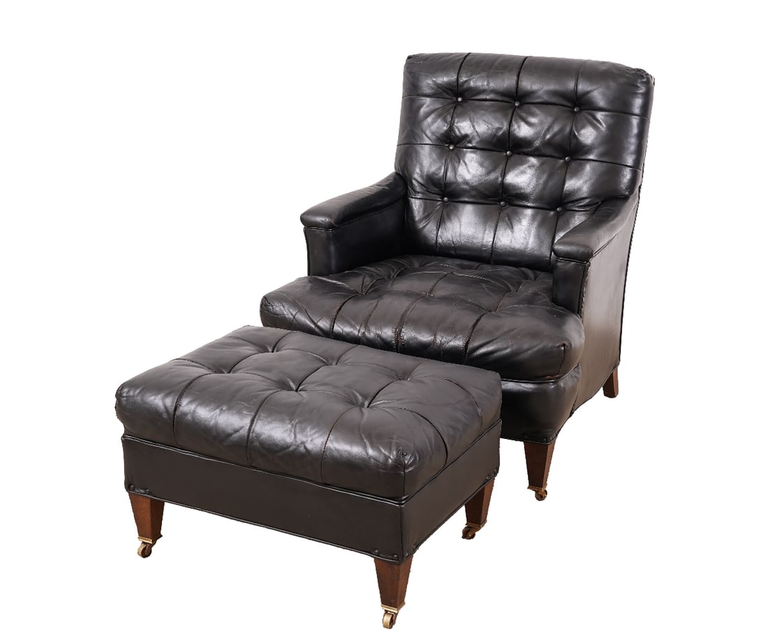 KITTINGER CLUB CHAIR & STOOL: Kittinger black leather club chair and stool with brass casters and matching stool. Chair: 33"h x 29"w x 33"d / 16" sh Stool: 15"h x 24"w x 17"d