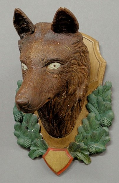Black Forest carved fox head, late 19th c., mounted on : Black Forest carved fox head, late 19th c., mounted on an oak leaf and acorn carved plaque. 8”h.x9.5”w.x9.5”d.