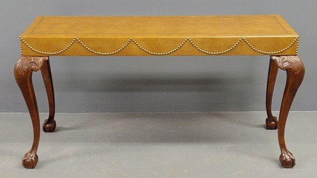 Chippendale style mahogany sofa table with mustard colo: Chippendale style mahogany sofa table with mustard color leather top with brass stud decoration and cabriole legs with ball and claw feet. 28”h.x52.5”l.x16”d.