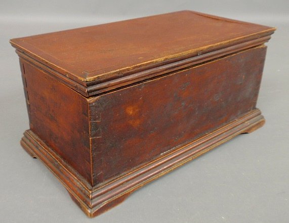 Miniature blanket chest, early 19th c., with old red pa: Miniature blanket chest, early 19th c., with old red paint decoration and dovetailed construction. 6”h.x12.5”w.