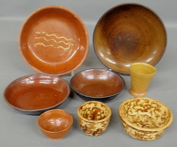 Four redware plates, largest 9”dia., tog. w/two Rocking: Four redware plates, largest 9”dia., tog. w/two Rockingham pieces, a small cup and bowl.