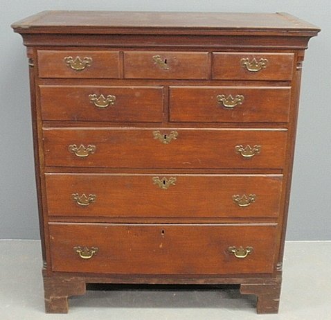 Pennsylvania Chippendale cherry three-quarter highcase,: Pennsylvania Chippendale cherry three-quarter highcase, c.1780, with molded cornice and fluted quarter columns. 46.5”h.x38”w.x23.5”d.
