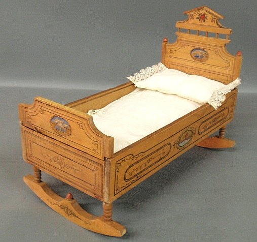 Maple doll crib, c.1890, with original paint decoration: Maple doll crib, c.1890, with original paint decoration and bedding. 12”h.x7.5”w.x16”l.