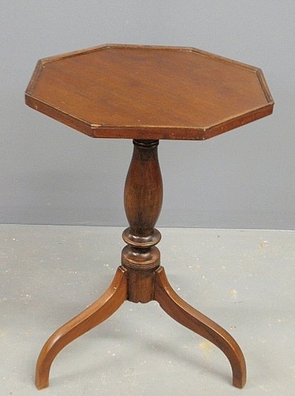 New England pine candlestand, 19th c., with an: New England pine candlestand, 19th c., with an octagonal top and spider legs. 26”h., top 17.5”x17.5”