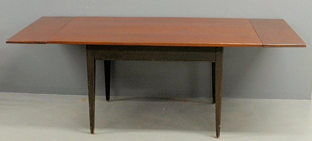 Country Hepplewhite style hand-planed cherry table with: Country Hepplewhite style hand-planed cherry table with end leaves and a green painted base. 30”h.x84”l.x37.5”w.