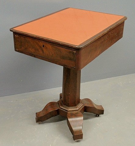 Empire mahogany work table with a drawer at each end,: Empire mahogany work table with a drawer at each end, center pedestal and four legs ending in casters. 30.5”h.x 25”x19”