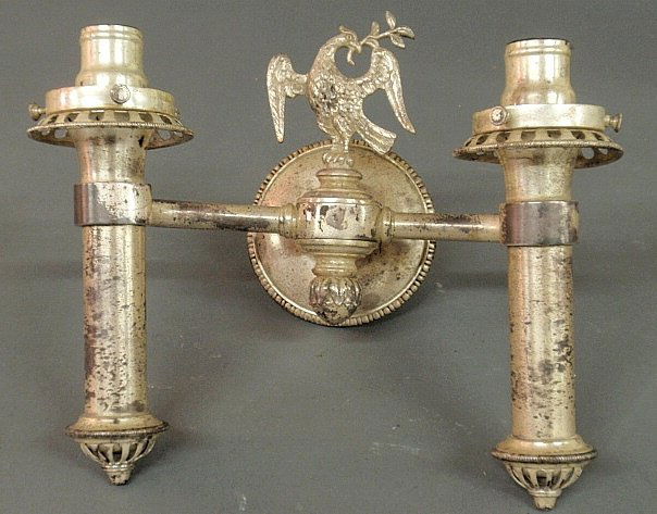 Silvered metal wall sconce, early 20th c., with a: Silvered metal wall sconce, early 20th c., with a spread winged eagle and label “General Electric Co.”. 9”h.x12”w.x7”d.