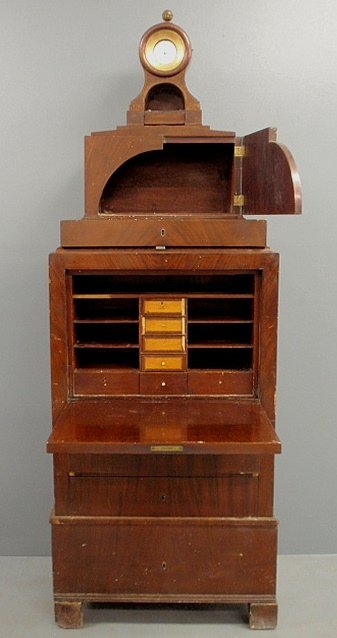Unusual secrétaire abbatant, c.1850, with a cornice: Unusual secrétaire abbatant, c.1850, with a cornice mounted clock with a porcelain dial, Arabic numerals, and the Fusee movement works signed “Antony Kluyt Leyden”. 85”h.x30”w.x18”d.