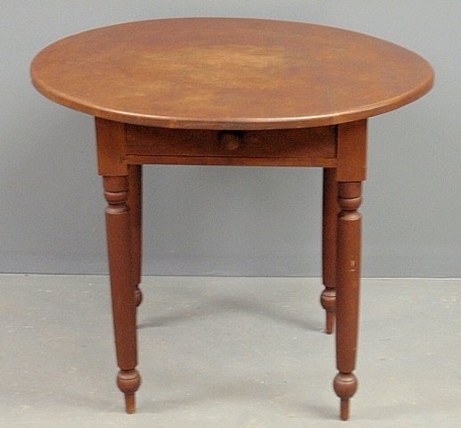 Sheraton style maple table with a round top.: Sheraton style maple table with a round top. 28.5”h.x32.5”dia.