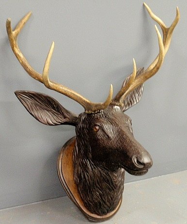 Large Black Forest stag head, late 19th c., with glass: Large Black Forest stag head, late 19th c., with glass eyes and natural horns. 33”h.x26”w.x17”d.