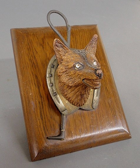 Carved fox head note holder, c.1900, with metal: Carved fox head note holder, c.1900, with metal horseshoe and whip mounted on an oak board. 9"x7"
