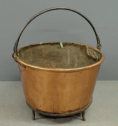Large copper apple butter kettle, early 19th c., with: Large copper apple butter kettle, early 19th c., with metal handle and wrought iron base. 21"h.x30"dia.