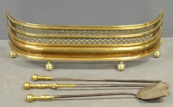 Brass fire fender, late 19th c., 11"h.x36.5"w. and: Brass fire fender, late 19th c., 11"h.x36.5"w. and three fireplace tools.