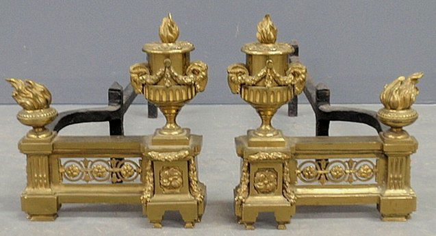 Pair of ornate French style brass chenets (andirons): Pair of ornate French style brass chenets (andirons) with flame finials. 11.5"h.x10"w.x23"d.