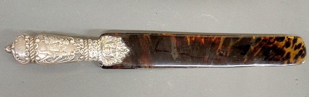English silver handled tortoiseshell page turner, early: English silver handled tortoiseshell page turner, early 19th c., the handle with a grotesque mask face, man and woman, hallmarked and marked "Made in England for Howard & Company". 17.5"l.