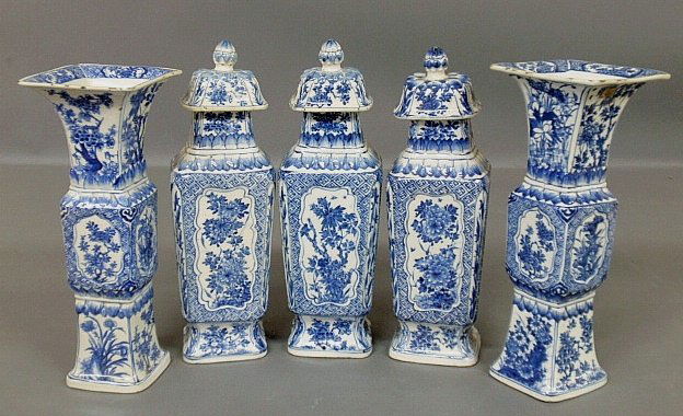 Delft blue and white porcelain five-piece garniture set: Delft blue and white porcelain five-piece garniture set, 19th c., with leaf and floral decorated panels, each approx. 13"h. w/bases 4"x3", the center three with lotus flower tops.