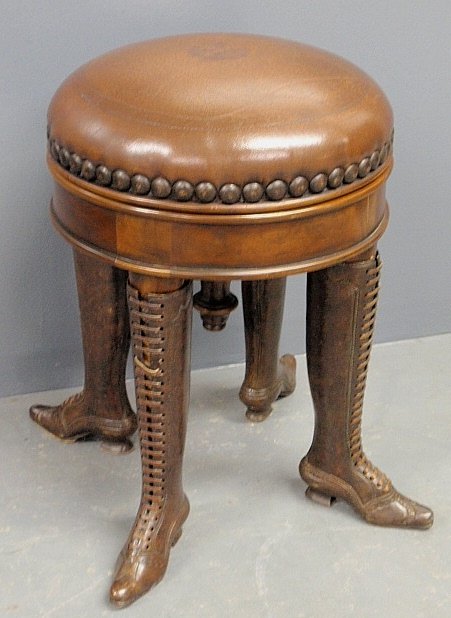 Unusual 19th c. style leather top mahogany piano stool,: Unusual 19th c. style leather top mahogany piano stool, the legs in the form of 19th c. ladies lace-up boots. 20"h.x15"dia.