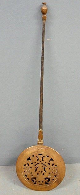 Hammered brass bed warmer with pierced lid, by Henry Ka: Hammered brass bed warmer with pierced lid, by Henry Kauffman, noted 20th c. Pennsylvania coppersmith,with an iron handle with brass tip and deaccession number from the Heritage Museum of Lancaster Co