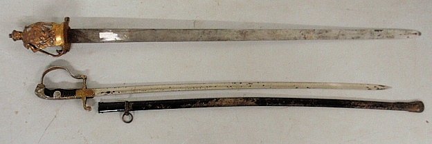 German World War II officers dress saber with lion head: German World War II officers dress saber with lion head handle and swastika 378"l., together with a Prussian 18thc. style basket hilt sword 43.5"l.