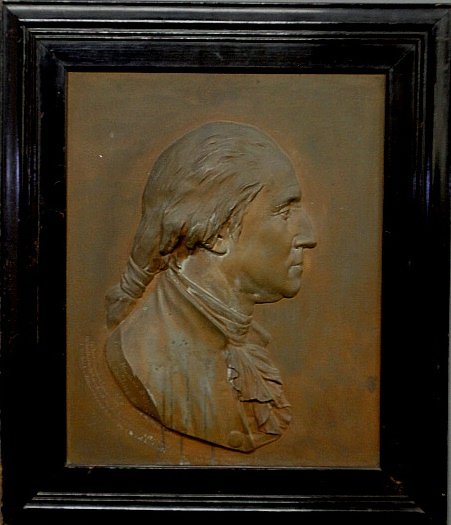 Faux bronze metal raised relief side profile of George: Faux bronze metal raised relief side profile of George Washington marked â€œFrom Houdon's bust, by C. Calverley. So. 1877" and mounted in an ebonized frame. Overall 27"x23"