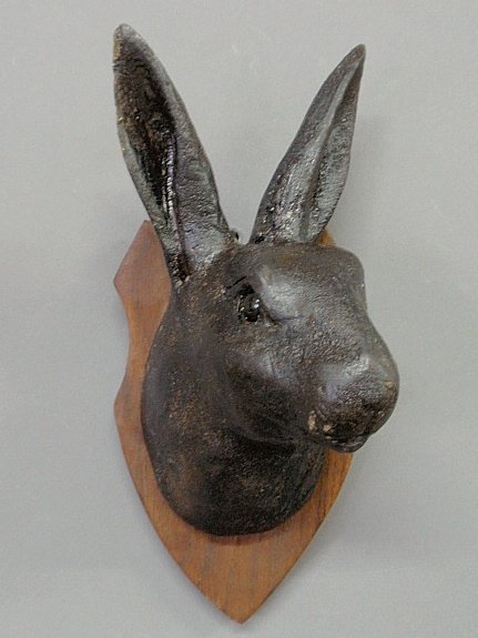 Black Forest caved rabbit head, late 19th c., with glas: Black Forest caved rabbit head, late 19th c., with glass eyes and mounted on a plaque of a later date. 11.5”h.x5.5”w.x6”d.