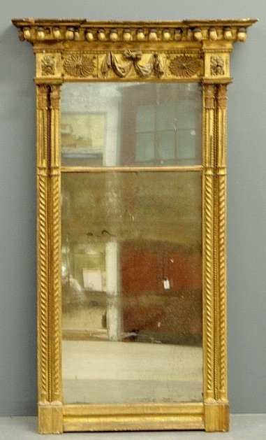 Large gilt wood pier mirror, 19th c., with an ornately: Large gilt wood pier mirror, 19th c., with an ornately carved cornice and original mirror glass. 62h.x30"w.x6.5"d."