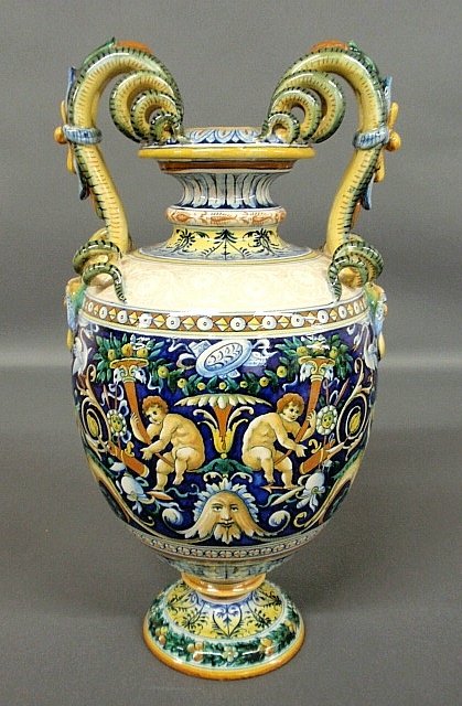 Colorful Italian faience urn with serpent-form and mask: Colorful Italian faience urn with serpent-form and mask handles and extensive and ornate decoration. 13"h.x8"dia.