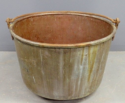 Large copper apple butter kettle, 19th c., with wrought: Large copper apple butter kettle, 19th c., with wrought iron swing handle. 19"h.x28"dia.