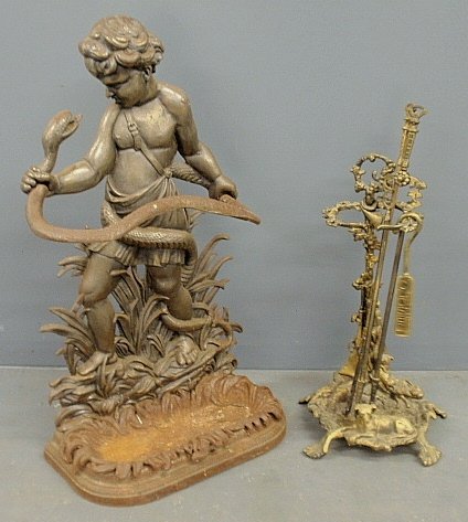 Victorian style cast iron umbrella stand in the form of: Victorian style cast iron umbrella stand in the form of a boy with a snake, 32"h.x18"w. tog. w/a brass fireplace tool set, 26" h.