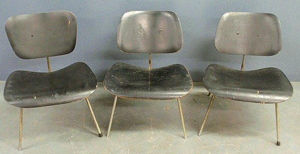 Three mid-century modern black painted plywood and: Three mid-century modern black painted plywood and chrome side chairs designed by Charles Eames, made by Evans Products Company, one with original label. 26"h.x22"w.x19"d., seats 14.5"h.