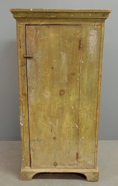 Pennsylvania pine green painted storage cupboard,: Pennsylvania pine green painted storage cupboard, c.1830, with a molded cornice above a single offset door and straight bracket feet. 58.5"h.x30"w.x21"d.